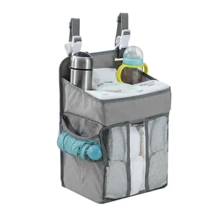 Detail of grey nursery organizer hanging bag showing diaper and bottle storage compartments