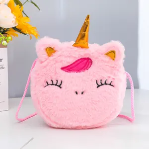 Detailed close-up of plush unicorn crossbody bag with soft fur and golden horn