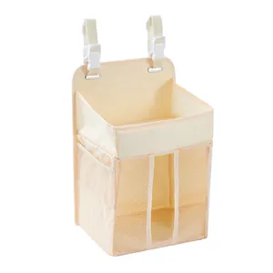 Macro view of beige bedside nursery organizer with mesh pockets and adjustable straps