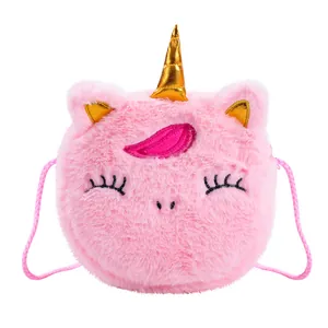 Close-up of pink plush unicorn crossbody bag with golden horn and soft faux fur texture