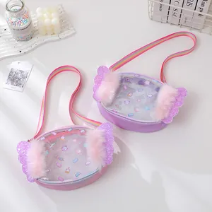 Kids glitter rainbow crossbody bag with wings and cartoon patterns on a desk