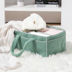 Detail of sage green teddy fleece storage caddy with reinforced handles and dividers