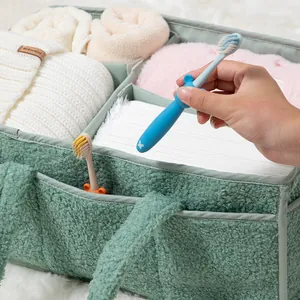 Macro detail of green teddy fleece nursery caddy organizer with multi-compartment storage