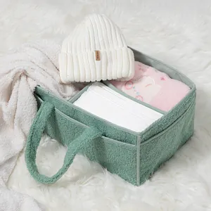 Close-up of the plush sage green teddy fleece storage basket with soft divided compartments