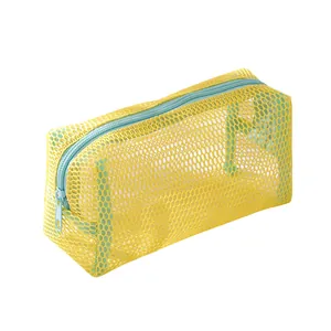 Detail view of yellow mesh stationery pouch with light blue zipper and durable nylon texture