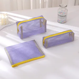 Three-piece purple mesh pouch set with yellow zippers for stationery or cosmetics