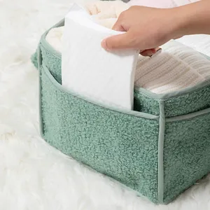 Close-up of light green fleece diaper caddy side pockets with soft teddy velvet texture