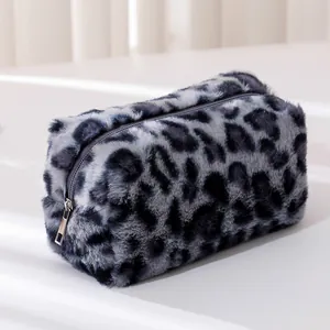 Detailed view of the soft leopard print faux fur plush makeup bag with silver zipper closure
