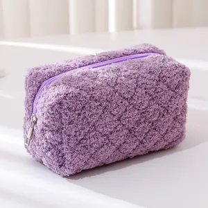 Detailed close-up of soft purple teddy fleece texture and matching zipper on pouch