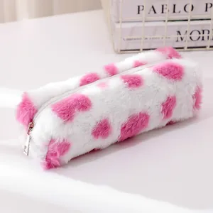 Detail view of pink cow print plush pencil case with soft faux fur and silver zipper