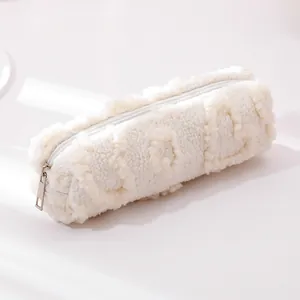 Close-up of white plush pencil case showing soft faux fur texture and silver zipper detail