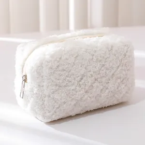 Close-up detail of soft white plush pencil case showing smooth zipper and fluffy texture