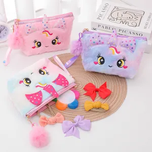 Detailed close-up of cute plush unicorn pouches with embroidery and pompom charm