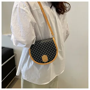 Detail of vintage saddle bag with geometric patterns and contrasting yellow trim