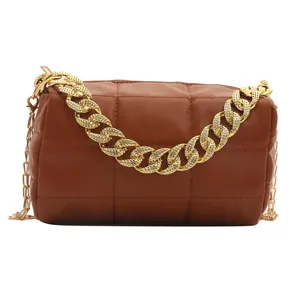 Quilted brown faux leather pillow bag with chunky gold chain and slim shoulder strap