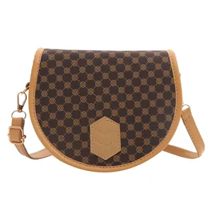 Vintage dark brown saddle bag with geometric flower print and adjustable strap