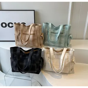 Detail of four canvas tote bags with checkered patterns and functional side pockets