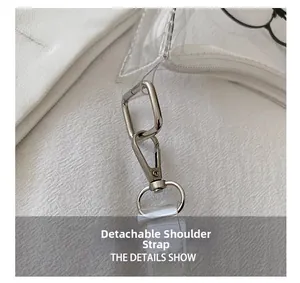 Detail of the clear PVC bag showing the removable shoulder strap and silver metal hooks
