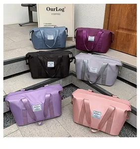 Detailed view of six colorful travel bags arranged on stone steps in a trendy cafe setting