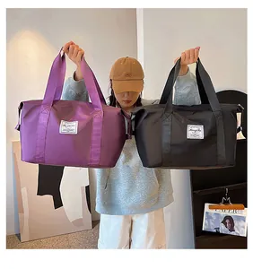 Close-up of large purple and black travel bags with waterproof nylon fabric texture