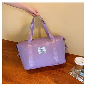 Detail of lavender travel bag with reinforced strap handle and fashion label patch