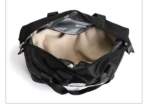 Interior view of black travel bag showing spacious main compartment and mesh pockets