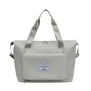 Detail view of large capacity waterproof gym bag with front zipper pocket and carry handles