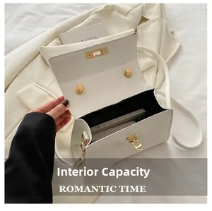 Internal capacity of the white leather square bag showing phone and cosmetics space