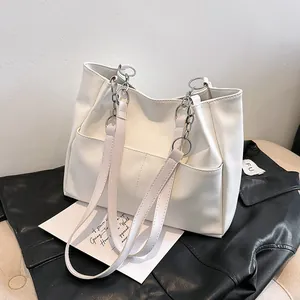 Minimalist beige PU leather tote bag with silver chain strap and front pockets