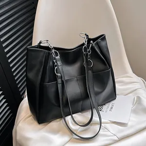 Minimalist black large capacity tote bag with matte finish and silver metal chain detail
