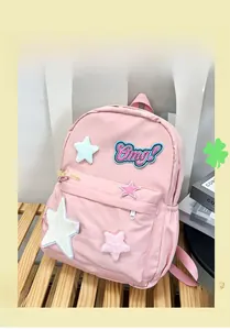 Detail view of pink student backpack with 3D star patches and embroidered Omg! lettering