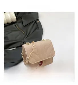 Top view of beige quilted mini chain bag with curved wave stitching details