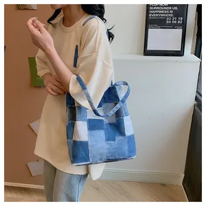 Detailed view of the checkered denim tote bag showing its large capacity on a model