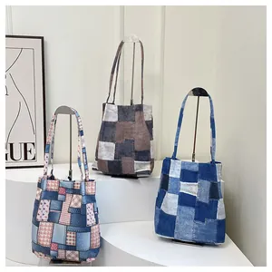 Detailed display of three stylish patchwork canvas tote bags on a boutique display stand