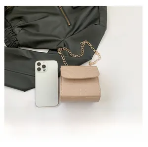 Size comparison of a beige quilted crossbody bag with a gold chain strap and a phone