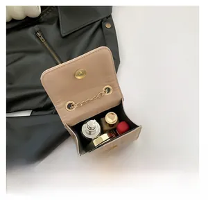 Macro shot of light brown quilted mini bag interior showing capacity for cosmetics