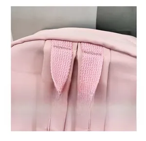 Detail shot of the reinforced pink nylon carrying handle on the large student backpack