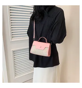 Straw and pink leather crossbody bag shown on model with chic summer outfit details