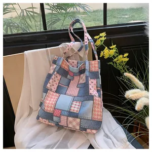Detailed patchwork canvas tote bag with mixed denim, plaid, and floral fabric squares