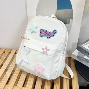 Detail of white backpack with colorful star patches and Omg! embroidery on wooden bench