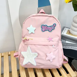 Detailed view of pink school backpack with star patches and embroidered Omg! text detail