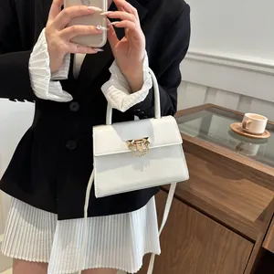 Chic white square crossbody bag with gold metallic lock and adjustable leather strap