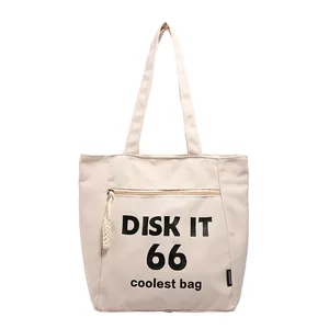Minimalist beige canvas tote bag with black Disk It text and functional zipper pocket