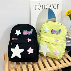 Large capacity student backpack in black and neon green with star patches and embroidery