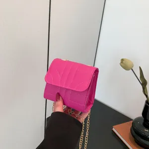 Fashionable hot pink quilted mini crossbody bag with a gold chain strap for women