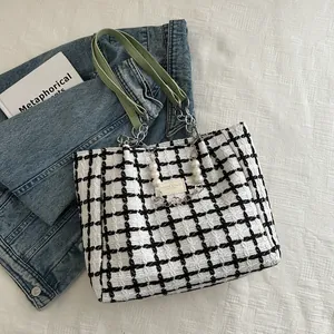 Classic black and white checkered tweed tote bag with light green leather strap and pearls