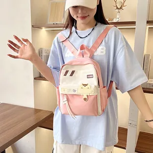Zaino per studenti minimalista rosa e bianco a grande capacità con orsetto