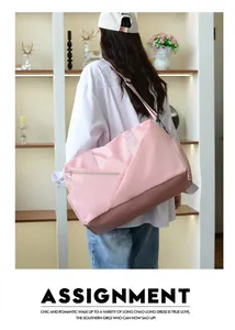 Pink and brown travel bag with dual zippers and adjustable strap shown on a model