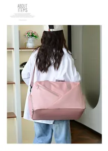 Pink travel bag with wet-dry separation and shoe compartment shown on model back