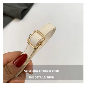 Detail of adjustable off-white PU leather shoulder strap with a gold square buckle